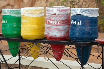 Four decorative trash bins in the form of vases for sorting of waste. The concept as it is possible...
