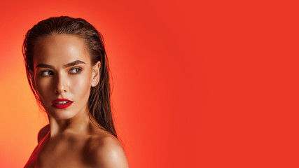 High Fashion model woman in red orange bright lights posing, portrait of beautiful girl with trendy...
