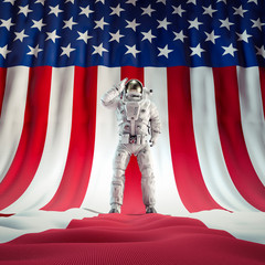 American hero astronaut / 3D illustration of science fiction scene with astronaut saluting USA flag