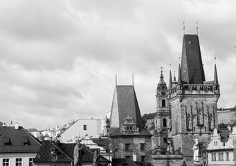 View of Charles bridge (Karluv Most) Lesser Town Bridge Tower and the tower of the Judith Bridge in black and white colors. 