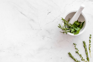Healing herbs for medicine on white marble background top view mockup