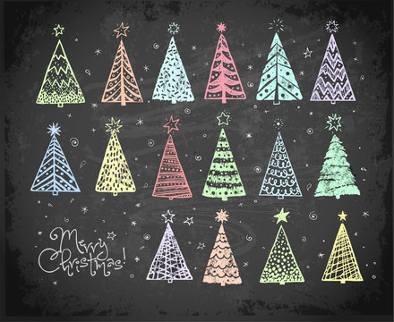 Doodle christmas trees hand drawn with colored chalks on blackboard background.
