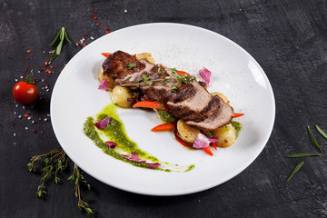 Close up view on tasty grilled and roasted beef with potato, forest mushroom on white plate. Restaurant food for lunch. Food photo background with copy space. Steak