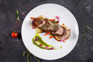 Close up view on tasty grilled and roasted beef with potato, forest mushroom on white plate. Restaurant food for lunch. Food photo background with copy space. Steak
