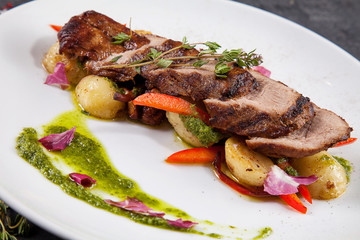 Close up view on tasty grilled and roasted beef with potato, forest mushroom on white plate. Restaurant food for lunch. Food photo background with copy space. Steak