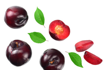 fresh plum fruit with green leaf and cut plum slices isolated on white background. top view