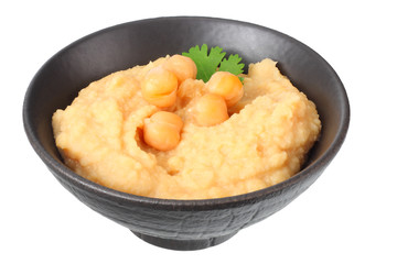 black bowl with chickpea hummus isolated on white background