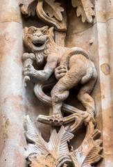 Fototapeta na wymiar Detail of dragon sculpted in stone in the porch of the cathedral, Salamanca, Spain