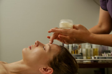Obraz na płótnie Canvas Face massage, a woman in the spa having anti-age face massage 