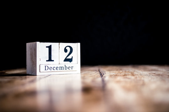 December 12th, 12 December, Twelth of December - White block calendar on vintage table - Date on dark background