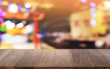 Empty dark wooden table in front of abstract blurred bokeh background of restaurant . can be used for display or montage your products.Mock up for space.