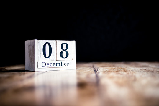 December 8th, 8 December, Eighth of December - White block calendar on vintage table - Date on dark background