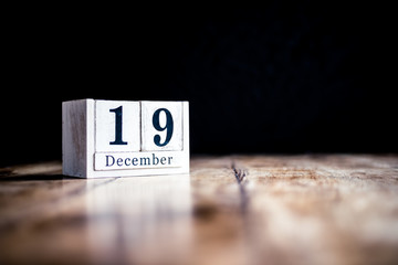 December 19th, 19 December, Nineteenth of December - White block calendar on vintage table - Date on dark background