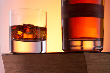 Old fashion whiskey on the rocks with a bottle