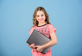 Child little girl with laptop computer. Little child using pc. Digital technology. Kid study with...