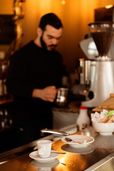 Bar counter with barman preparing coffee