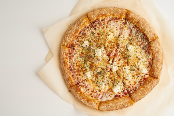 Italian pizza Four Cheese on baking paper top view