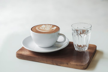 Coffee cup on table in cafe, on wooden