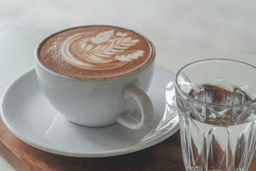 Coffee cup on table in cafe, on wooden