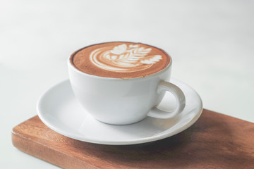 Coffee cup on table in cafe, on wooden