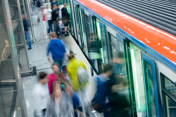 Passenger flow concept. People go on subway train. Passengers are blurred, movement is shown. Train...