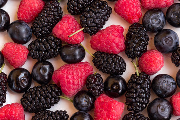 Berries: raspberries and blueberries, blackberries on a white plate. Top view