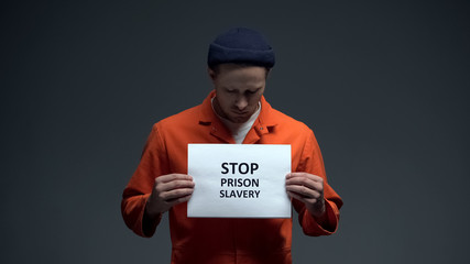 Fototapeta na wymiar Prisoner holding Stop prison slavery sign, human rights protection, violence