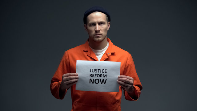 Caucasian Prisoner Holding Justice Reform Now Sign, Human Rights Protection