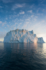 Nature and landscapes of Greenland or Antarctica. Travel on the ship among ices. Studying of a phenomenon of global warming Ices and icebergs of unusual forms and colors Beautiful midnight sun on ship © Michal