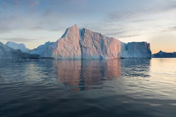 Gordijnen Nature and landscapes of Greenland or Antarctica. Travel on the ship among ices. Studying of a phenomenon of global warming Ices and icebergs of unusual forms and colors Beautiful midnight sun on ship © Michal