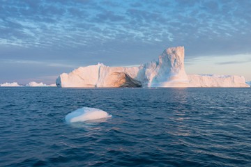 Nature and landscapes of Greenland or Antarctica. Travel on the ship among ices. Studying of a phenomenon of global warming Ices and icebergs of unusual forms and colors Beautiful midnight sun on ship © Michal