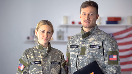 USA students of military academy with folders looking at camera, education