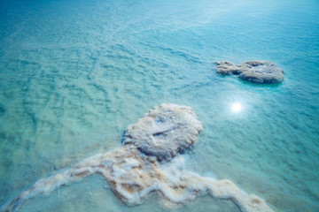 Blue natural background. The texture of the Dead Sea. Salty sea shore background