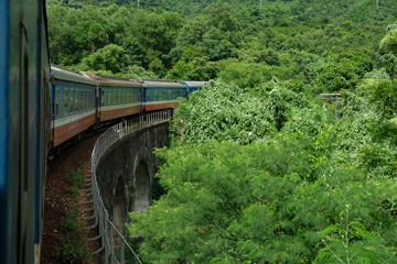 Obraz na płótnie Canvas Da Nang, Vietnam - August 19: Train running through Hai Van Pass in the middle center of Vietnam on August 19, 2018 in Da Nang, Vietnam.