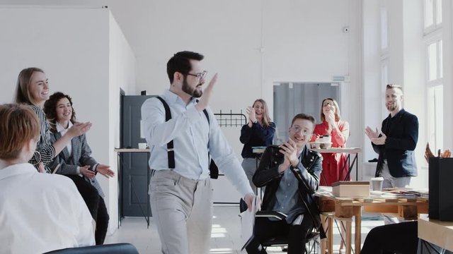 Happy smiling Caucasian manager man entering office celebrating success with team cheering him up slow motion RED EPIC.