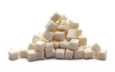 Coconut cubes, pieces, healthy sliced and diced snacks isolated on white background