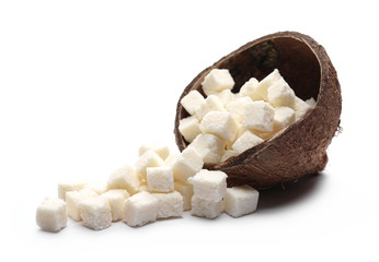 Coconut cubes, pieces, healthy sliced and diced snacks with shell isolated on white background