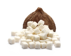 Coconut cubes, pieces, healthy sliced and diced snacks with shell isolated on white background
