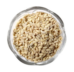 Peeled barley grains in bowl isolated on white background, top view