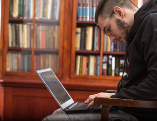 Schoolboy is working for exams in laptop