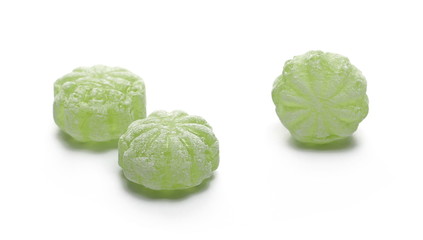 Green hard menthol candies isolated on white background