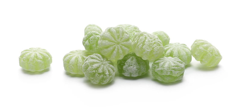 Green hard menthol candies isolated on white background