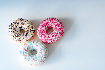 three delicious donuts on white background