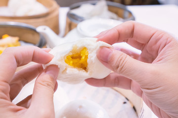Delicious dim sum, famous cantonese food in asia, fresh and hot salted creamy custard buns in...