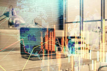 Stock market chart with globe hologram and desktop office computer background. Multi exposure....
