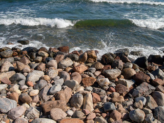Fototapeta na wymiar Tranquility beach during sunny day with big round rocks