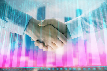 Double exposure of financial graph on cityscape background with two businessman handshake. Concept of stock market deal