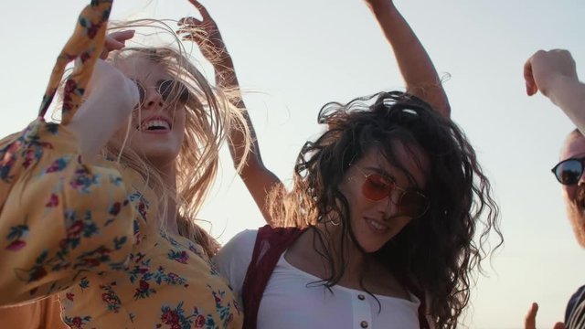 Young people dancing on the beach 