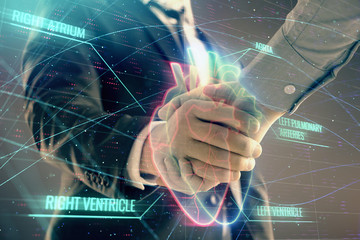Multi exposure of heart hologram on abstract background with two men handshake. Concept of medical education
