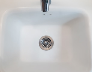 wash basin close-up, basin and tap flowing , white wash basin close up, Bathroom sign toilet, Detail of the basin, working water tap, water flowing from the tap in the sink close-up, Water tap flowing